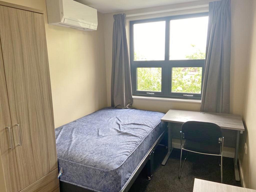 This inviting double bedroom features a comfort...