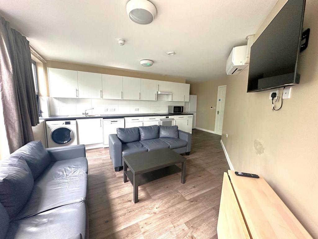 Bright open-plan living area with a fitted kitc...