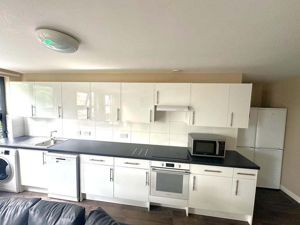 Bright modern kitchen with glossy white cabinet...