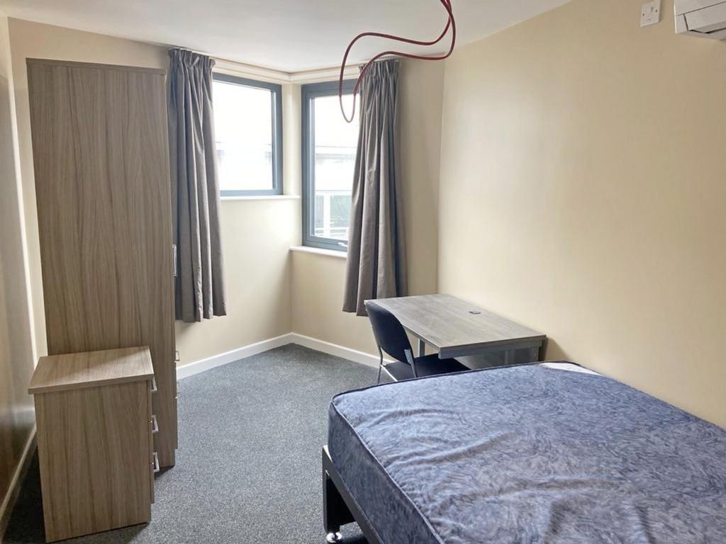 Bright and spacious double bedroom featuring la...