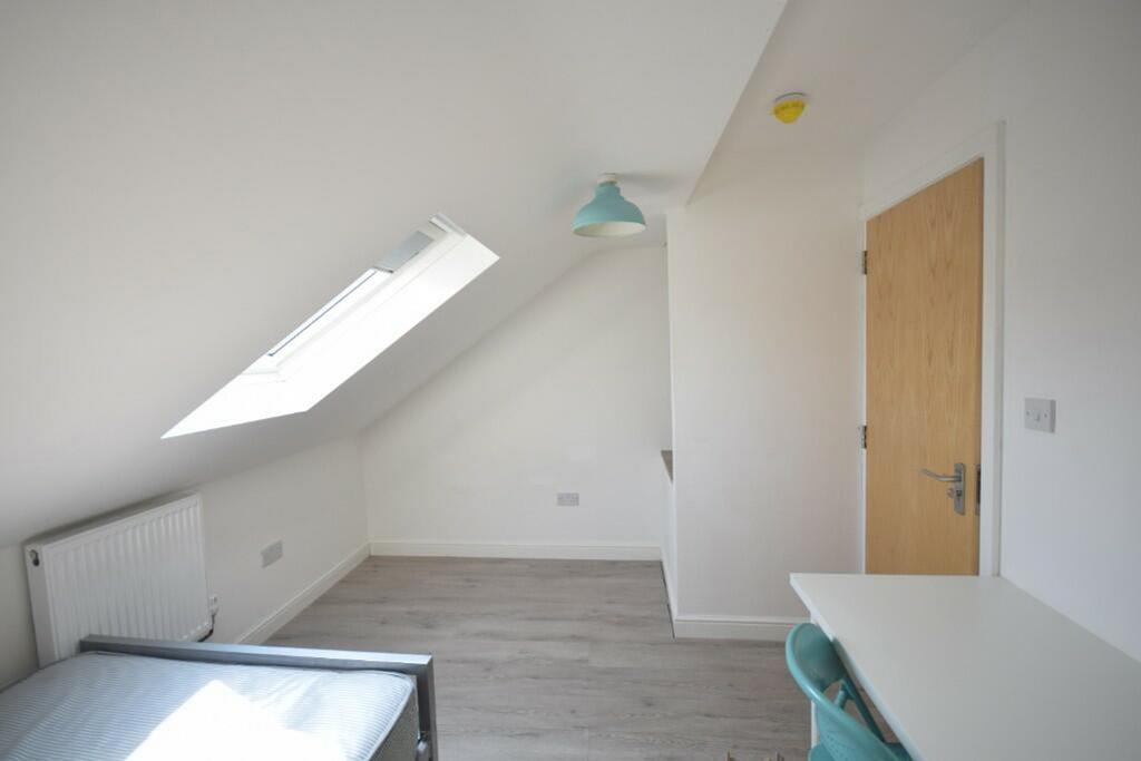 A bright and inviting double bedroom with moder...