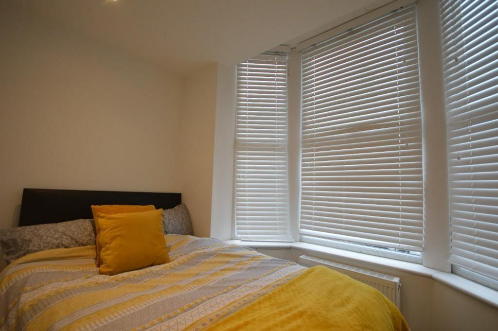 Bright and inviting double bedroom featuring la...