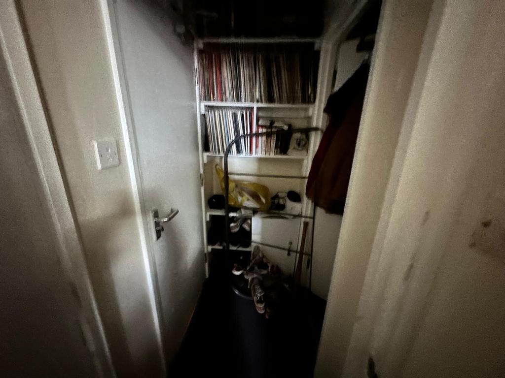A compact storage area with various items organ...