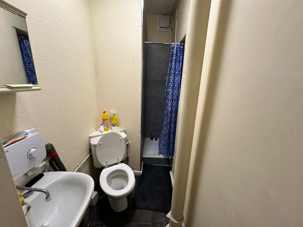 A compact and functional bathroom featuring a s...