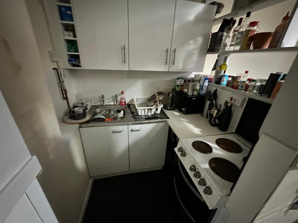 A functional kitchenette featuring essential ap...