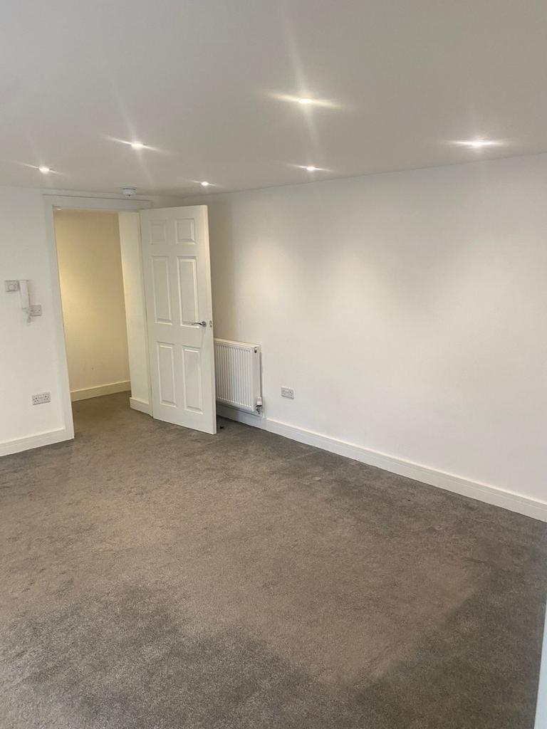 A spacious and well-lit modern living room, per...