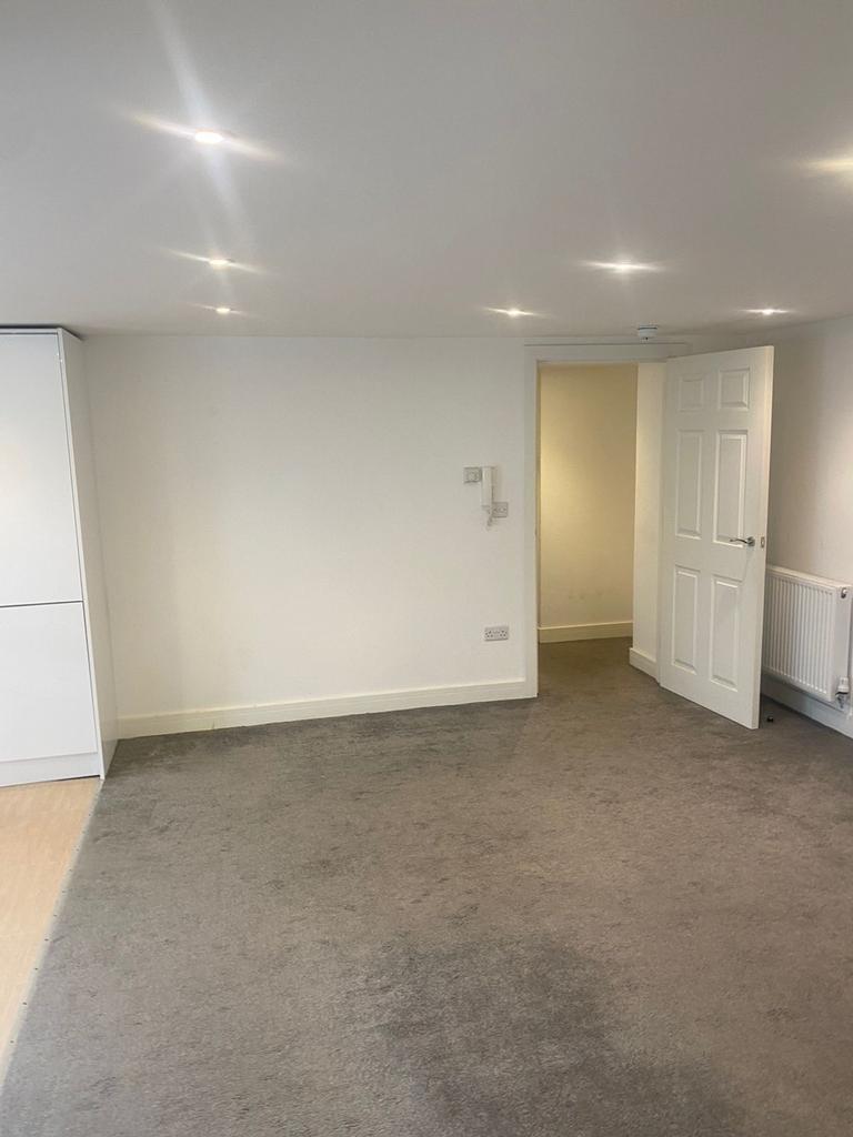 A spacious and well-lit living room, perfect fo...