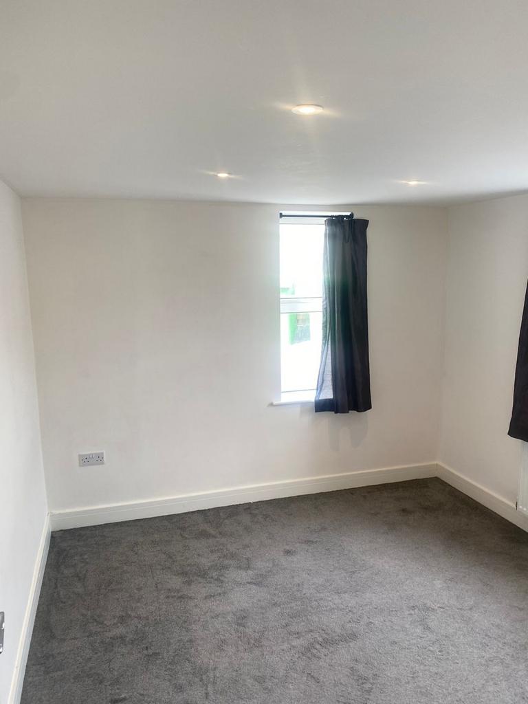 A spacious and bright double bedroom featuring ...