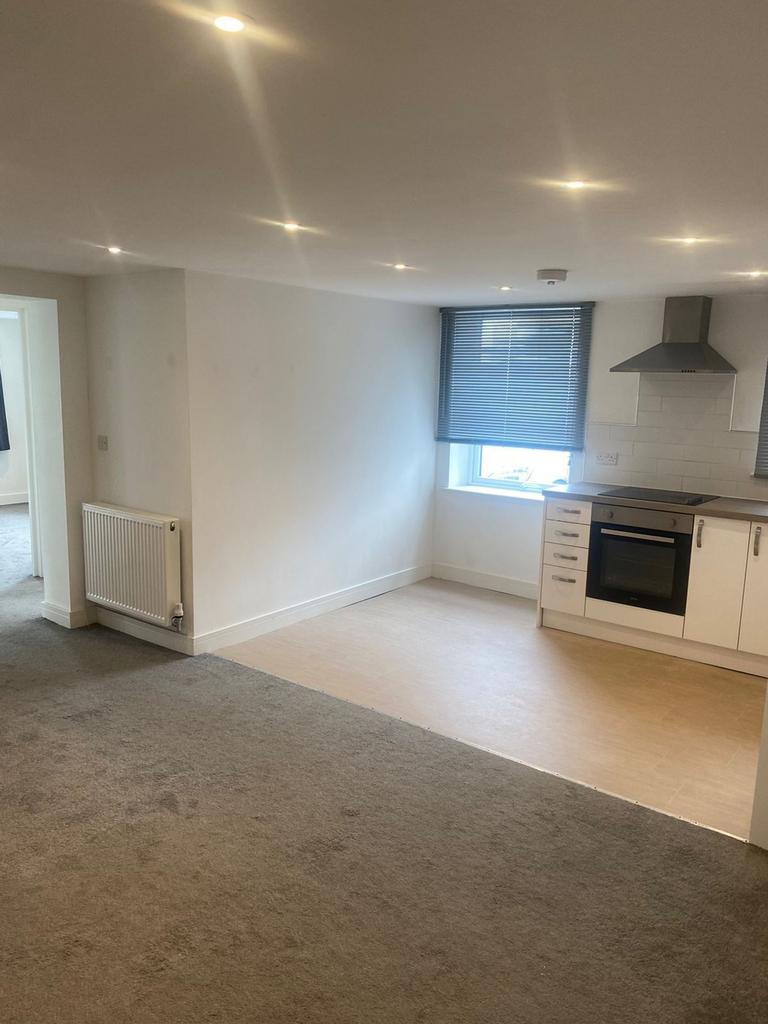 A bright and modern kitchenette with ample spac...