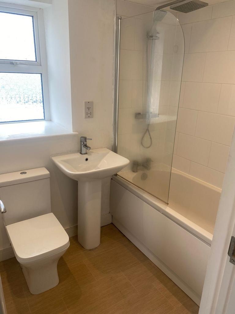 A modern and clean bathroom featuring a shower ...
