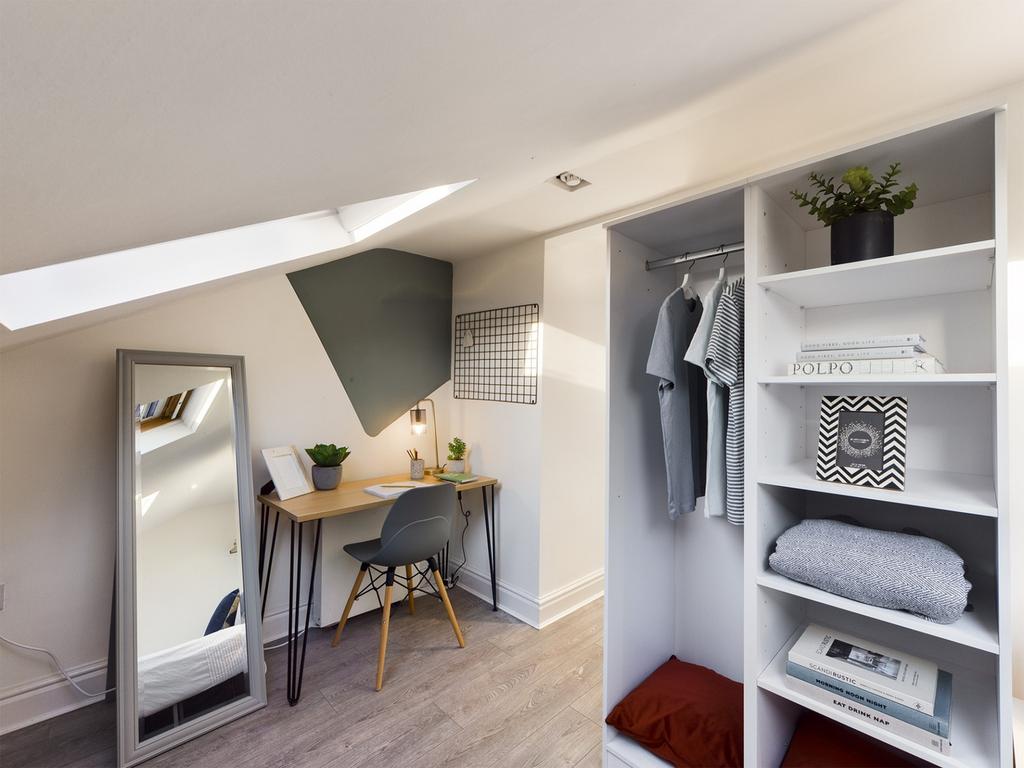 A bright and tidy double bedroom featuring a st...