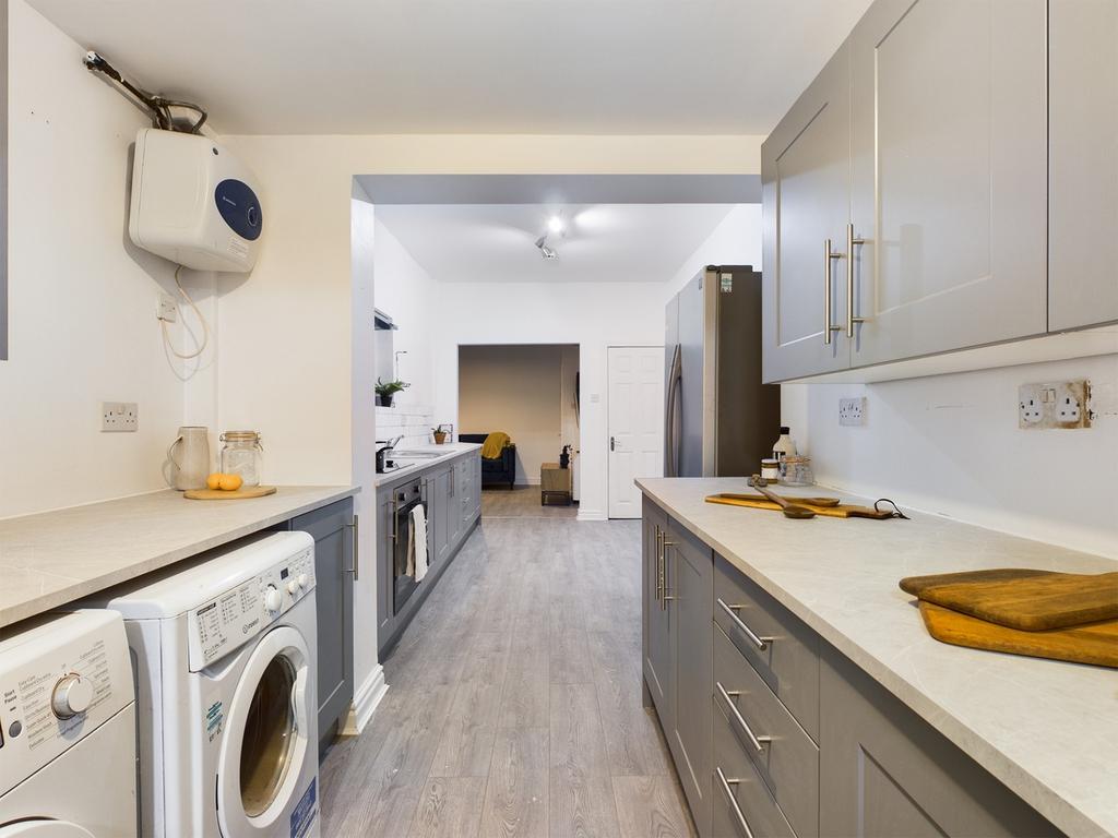A bright and modern kitchen featuring ample cou...