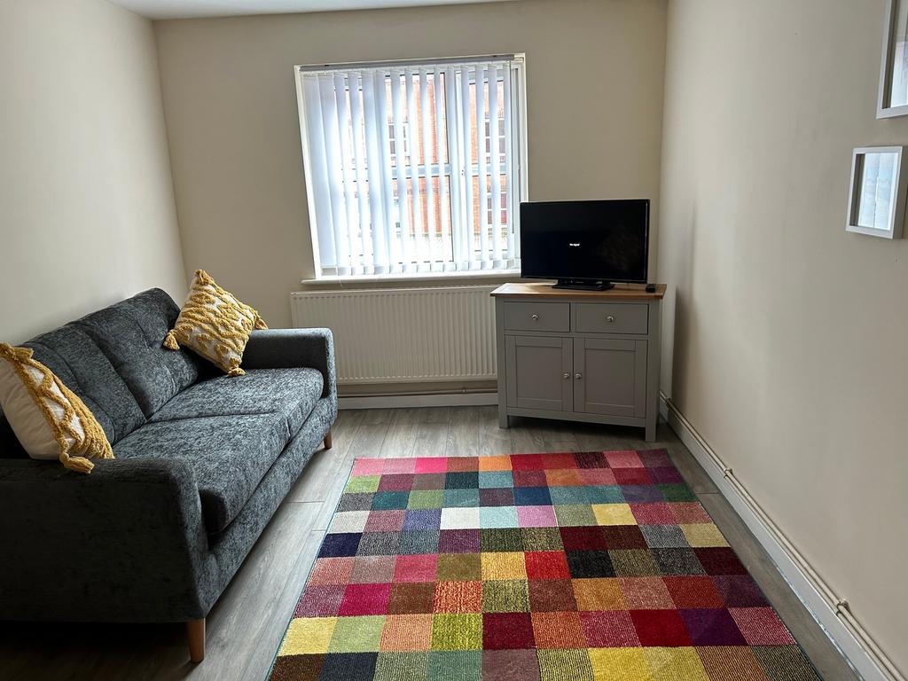 A cozy living room featuring a comfortable sofa...