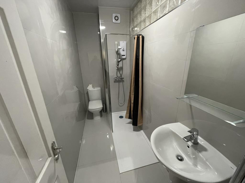A modern and impeccably clean bathroom featurin...