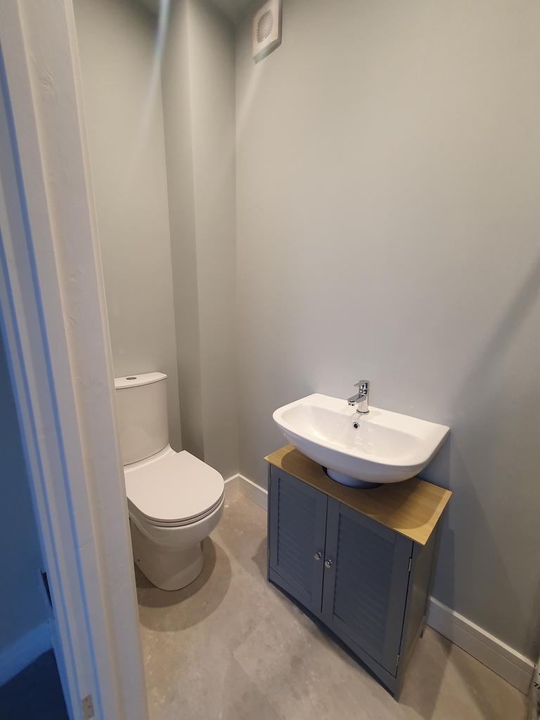 A modern and clean single toilet with stylish f...
