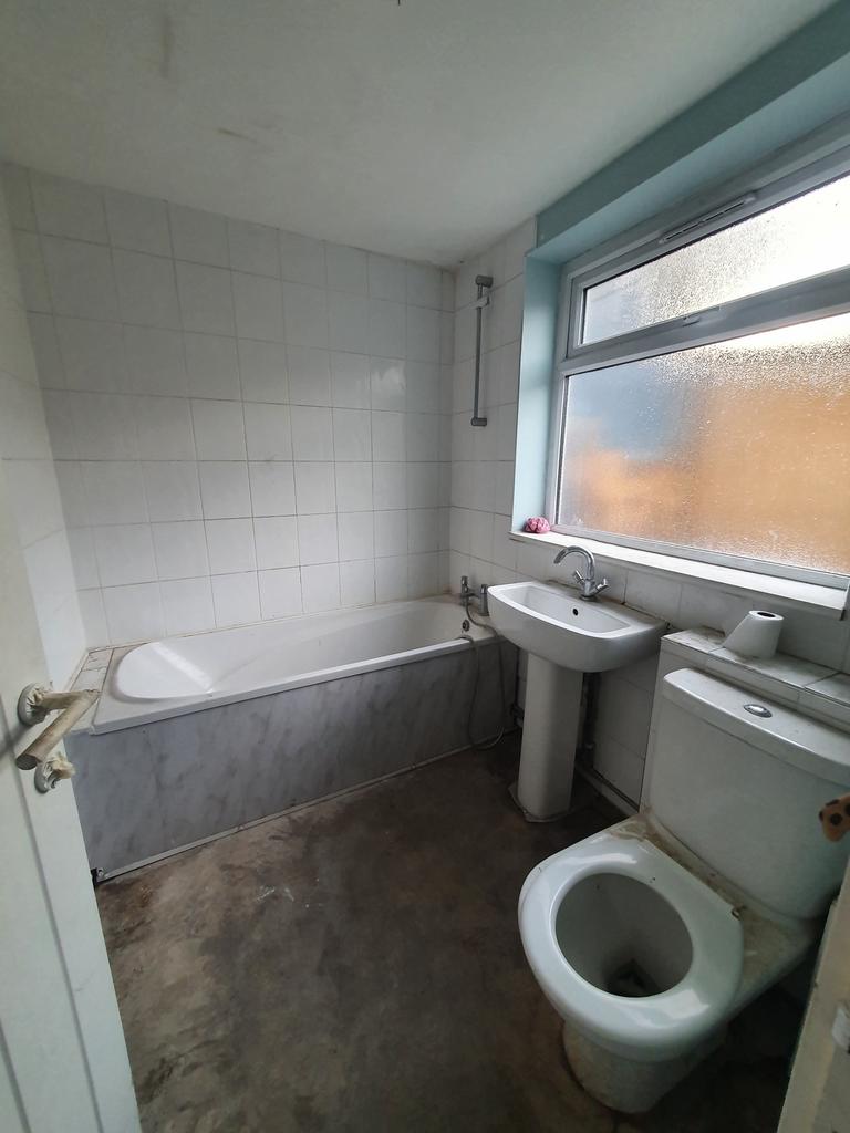 A functional bathroom featuring a bath and natu...