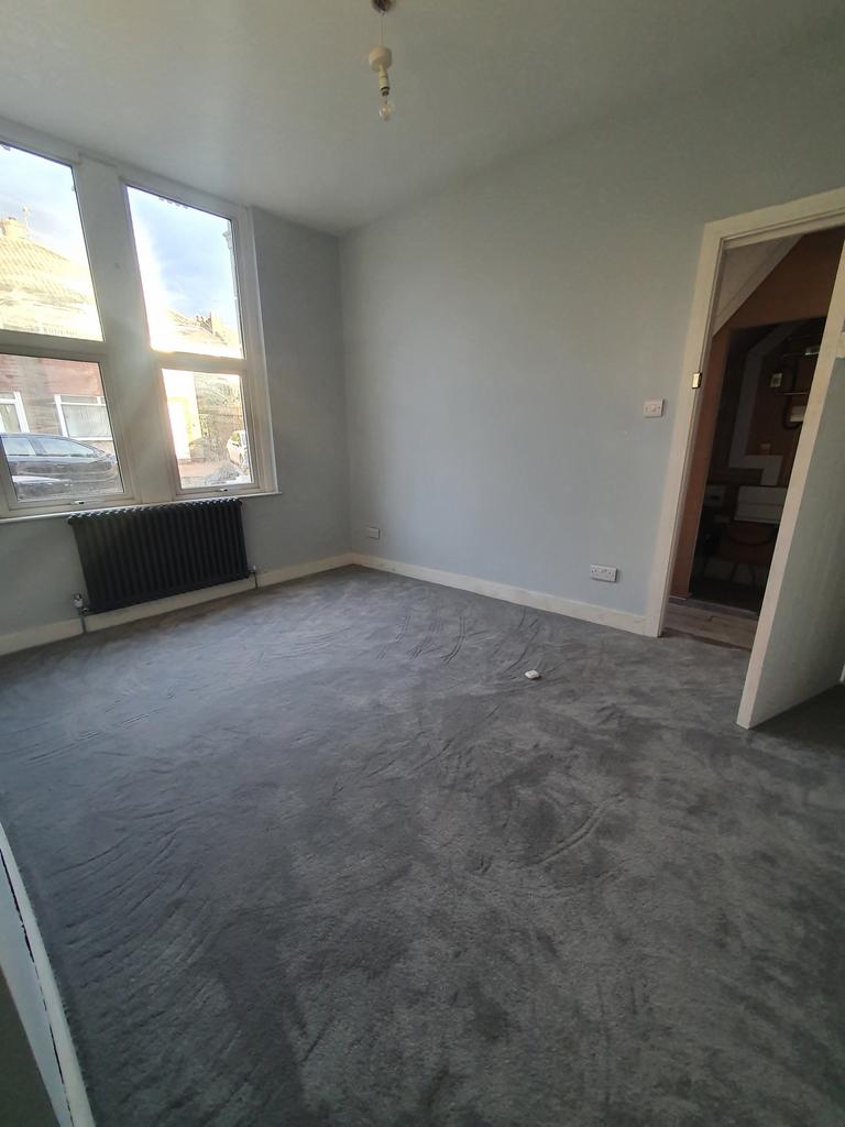 A spacious and bright double bedroom with large...