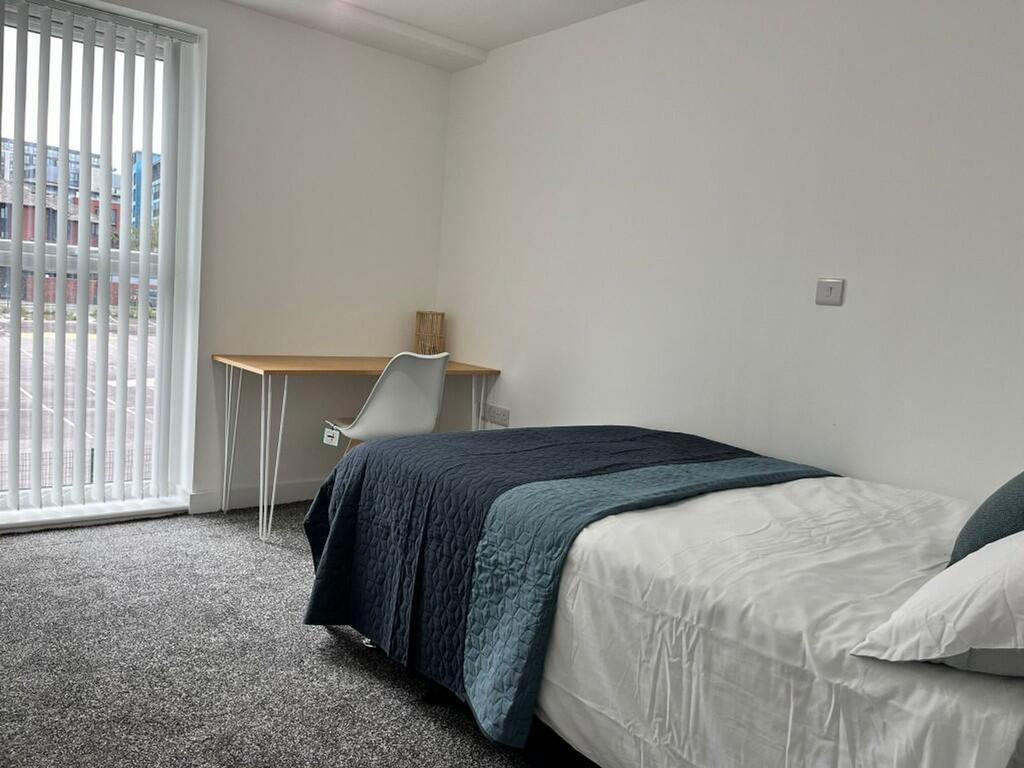A bright and tidy double bedroom featuring a co...