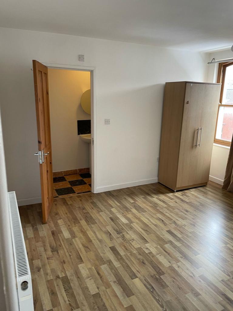 A bright and spacious double bedroom featuring ...