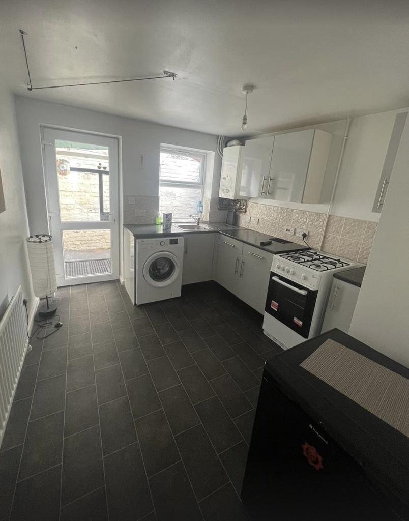 A tidy kitchen with modern appliances, featurin...