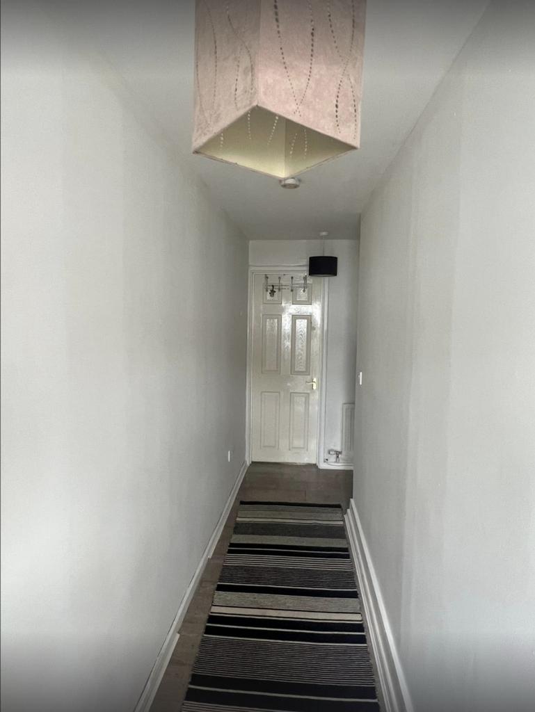 A clean and well-maintained hallway with neutra...