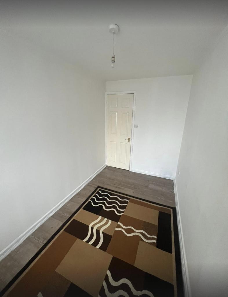 A simple and clean hallway with a patterned rug...