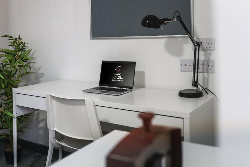 A bright and tidy communal workspace equipped w...