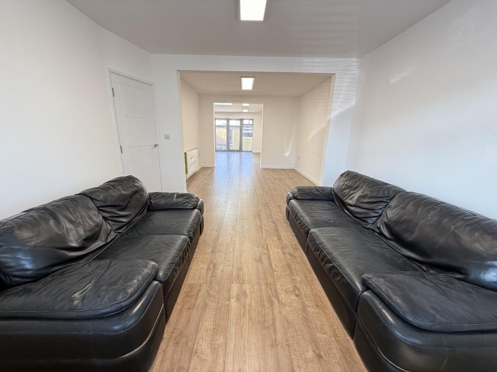 Open-plan lounge leading to the kitchen