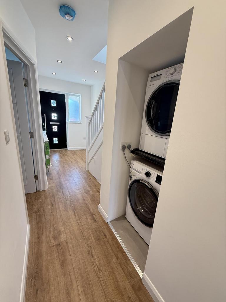 Passage with neatly placed washing machine and dr