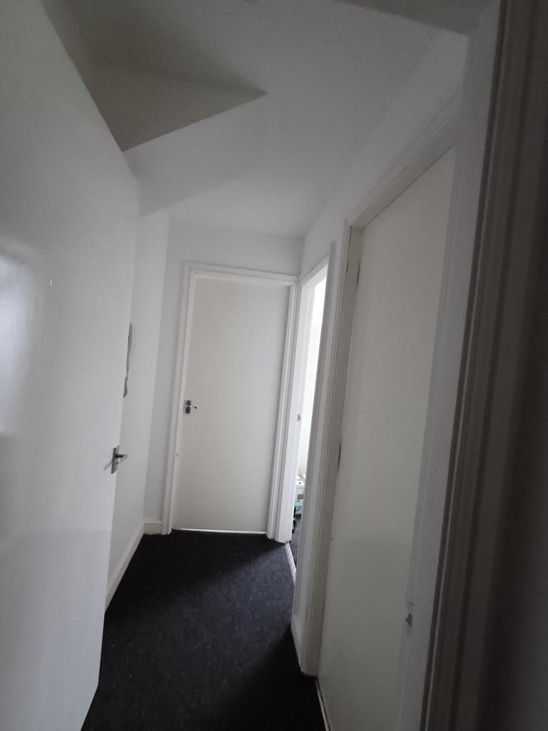 A well-maintained hallway featuring clean, whit...