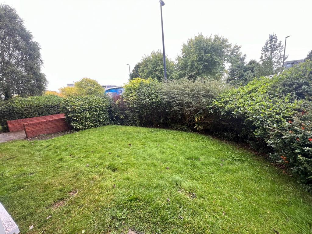 A well-maintained garden area featuring lush gr...