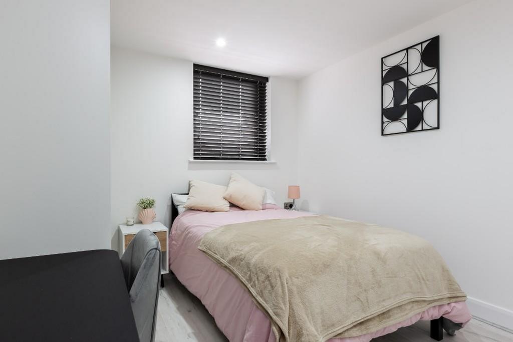 A bright and inviting double bedroom featuring ...
