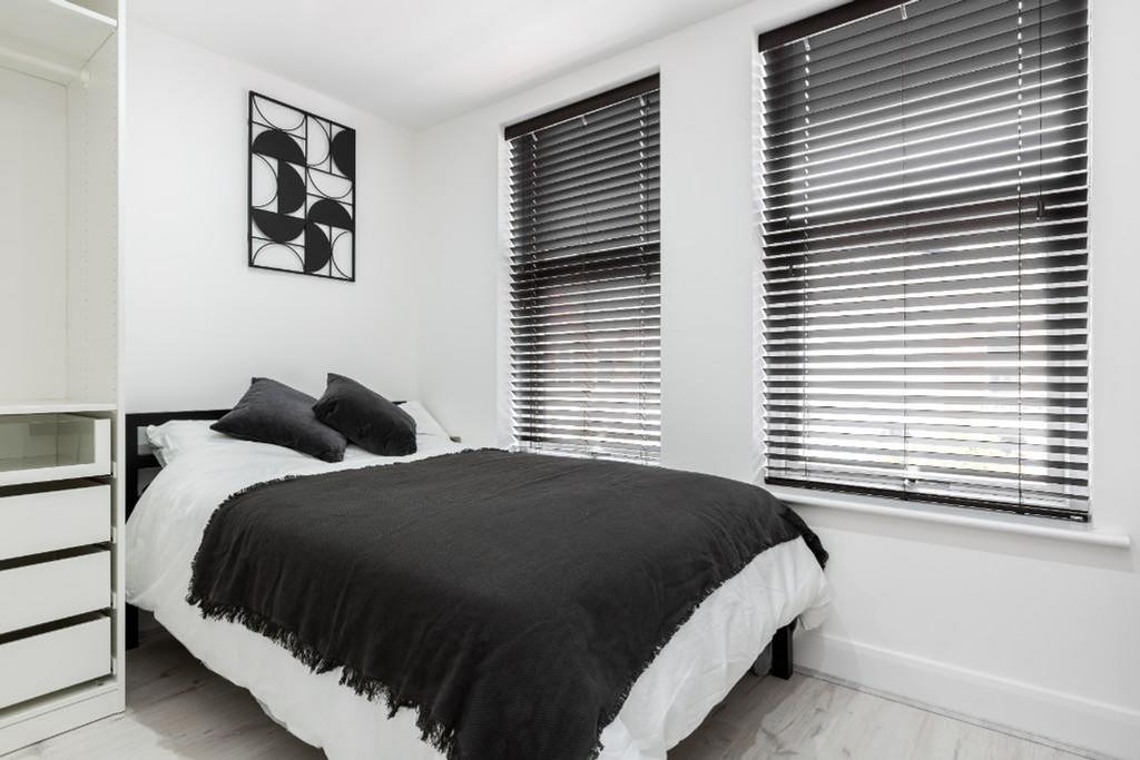 A stylish and well-lit double bedroom featuring...