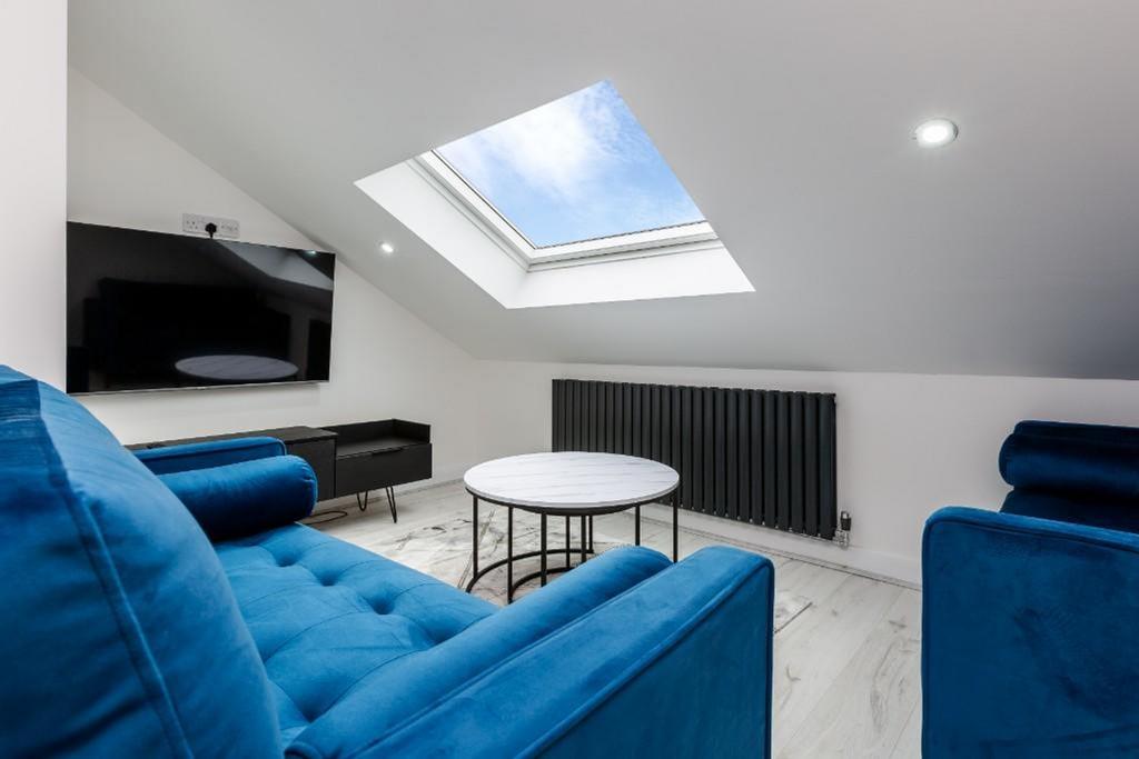 A stylish and well-lit living room featuring mo...