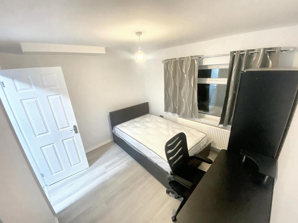 Bright and spacious double bedroom featuring a ...
