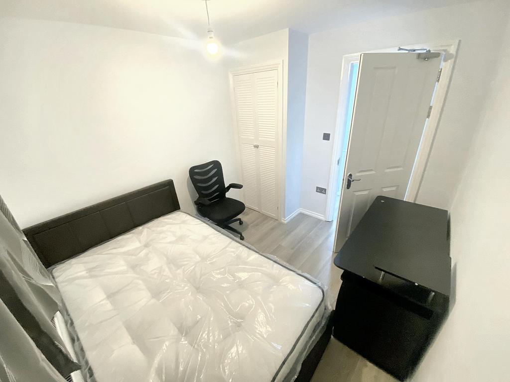 Cozy double bedroom featuring a comfortable bed...