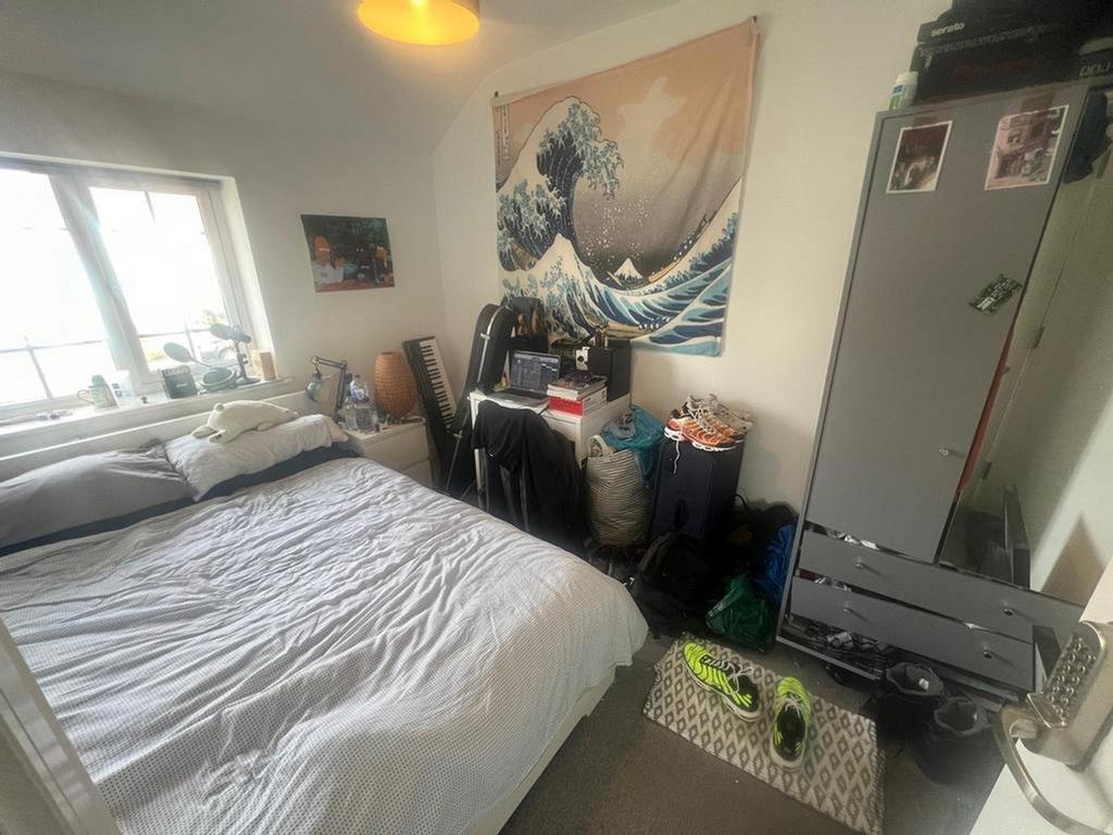 A cozy double bedroom with ample natural light ...