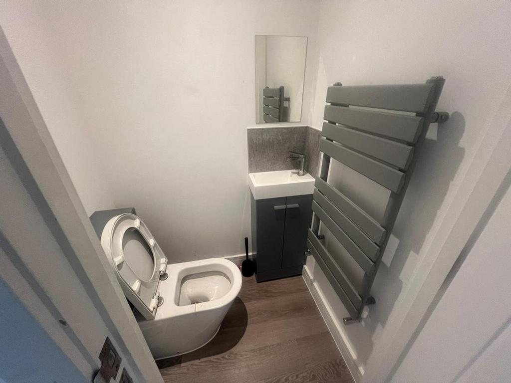 A clean and modern single toilet with contempor...