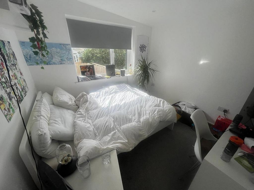 A bright and inviting double bedroom with ample...