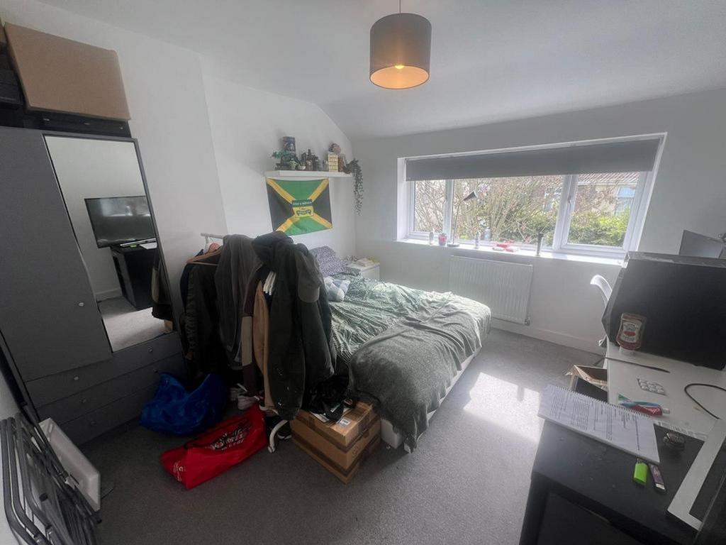 A spacious double bedroom with ample natural li...