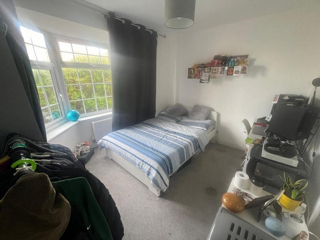 A bright and inviting double bedroom with ample...
