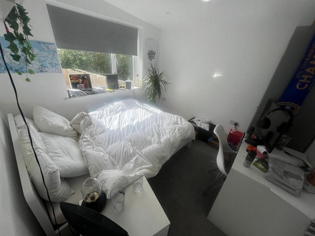 A bright and inviting double bedroom with ample...