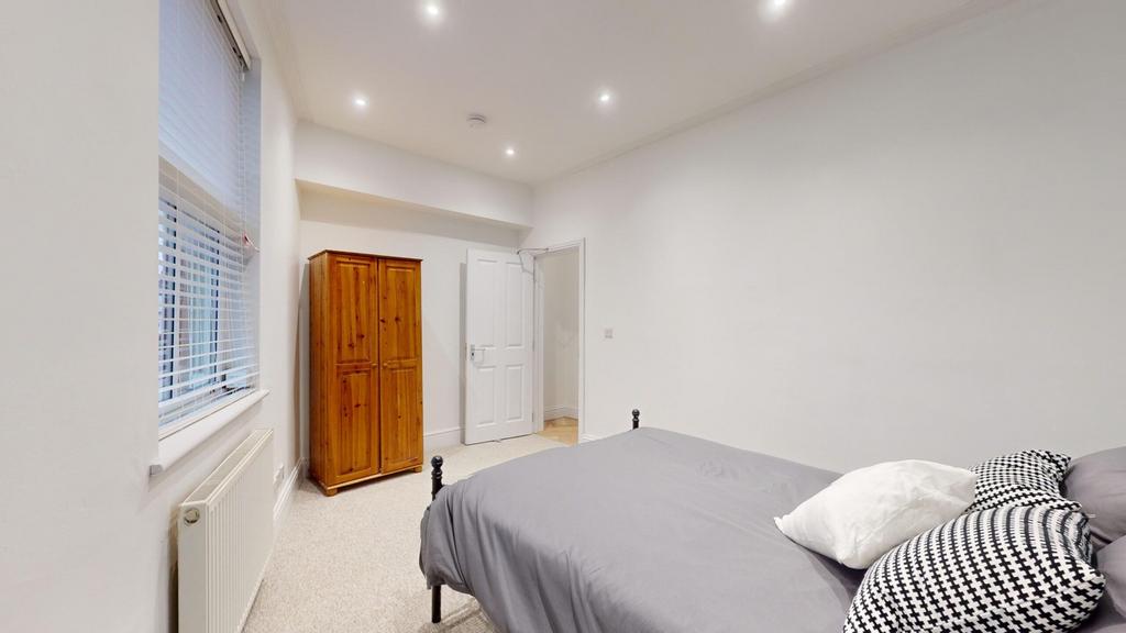 A spacious and inviting double bedroom featurin...