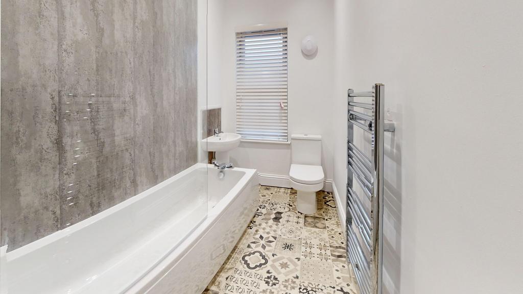A modern and stylish bathroom featuring a bath ...