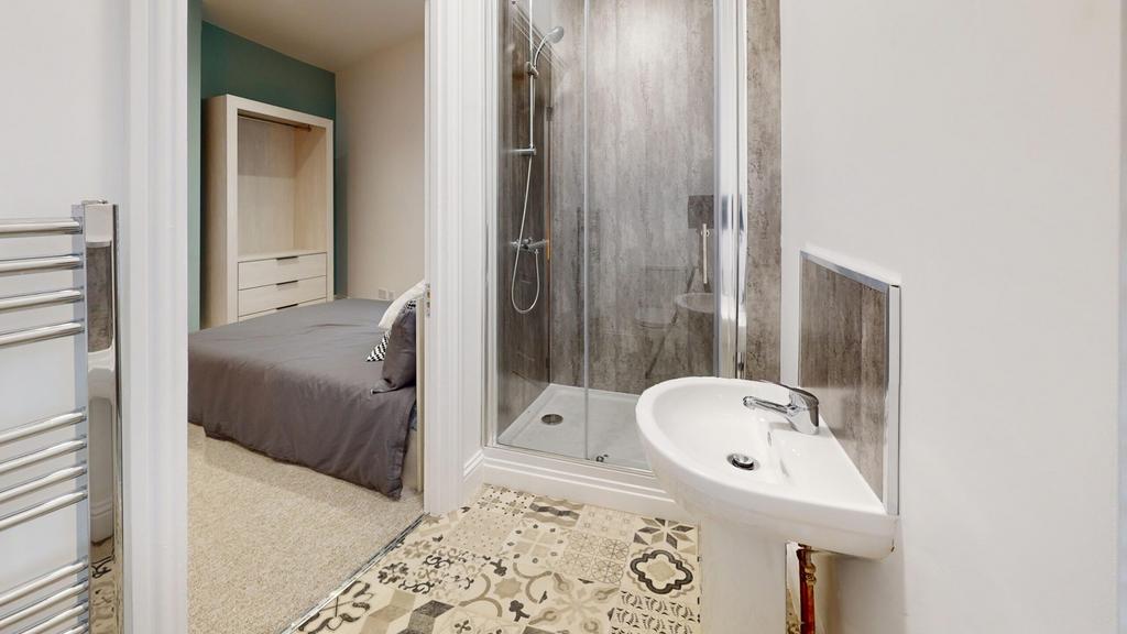 A spacious and modern bathroom featuring a styl...
