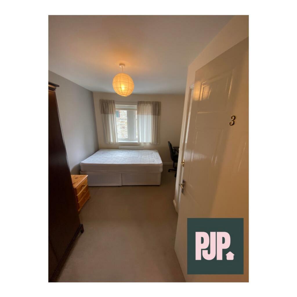 Spacious double bedroom featuring ample natural...