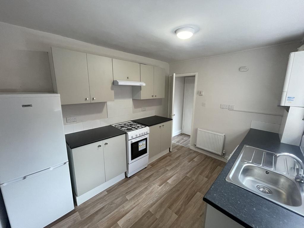 Bright, modern kitchen with fitted cabinets, fu...