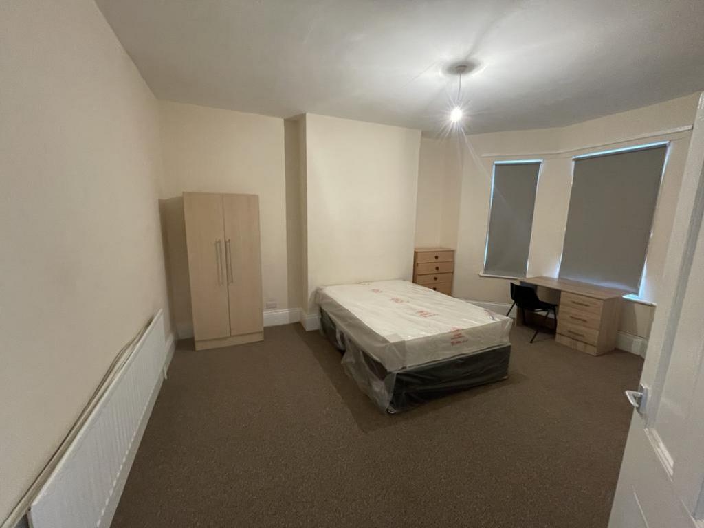 Spacious double bedroom featuring a comfortable...