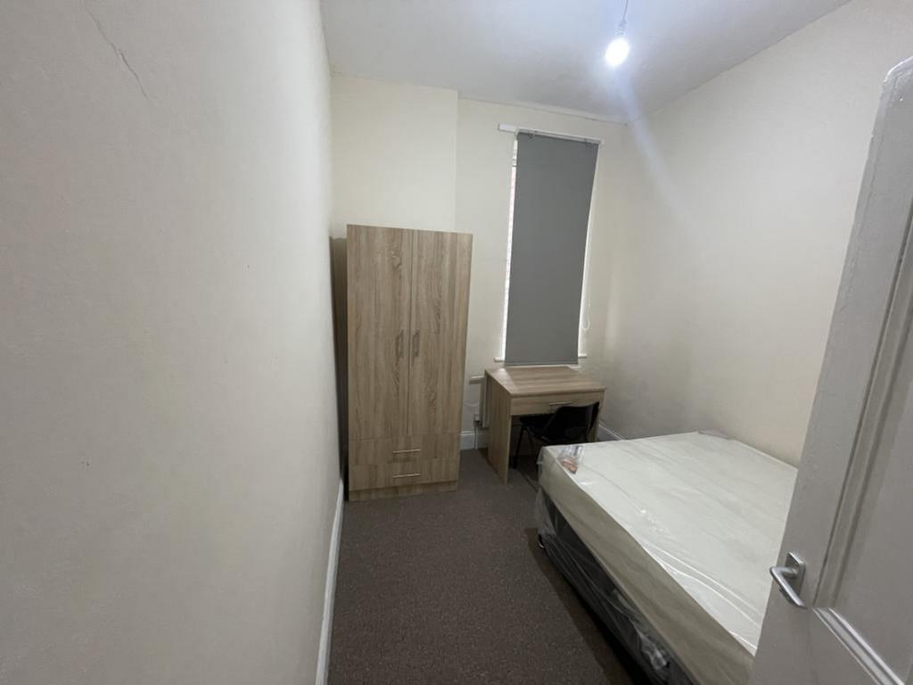 Cozy double bedroom featuring a comfortable bed...