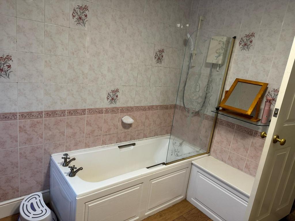 This inviting bathroom features a stylish batht...
